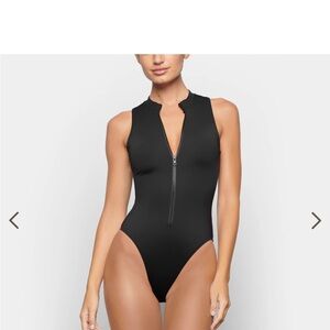 Skims swim zip front sleeveless one piece. Size medium Brand new with tags.